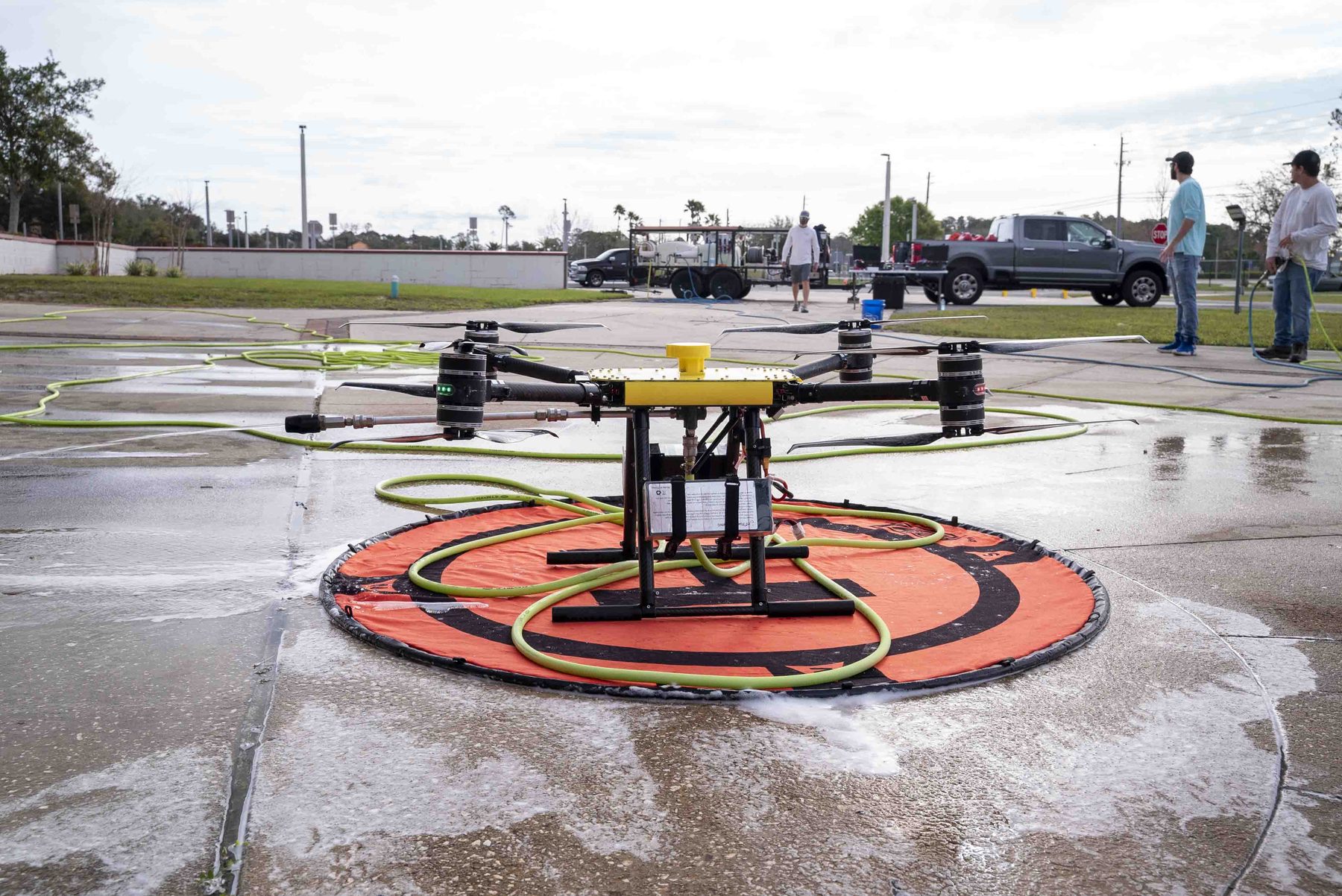Exo-Pro soft wash drone on the landing pad on a job site